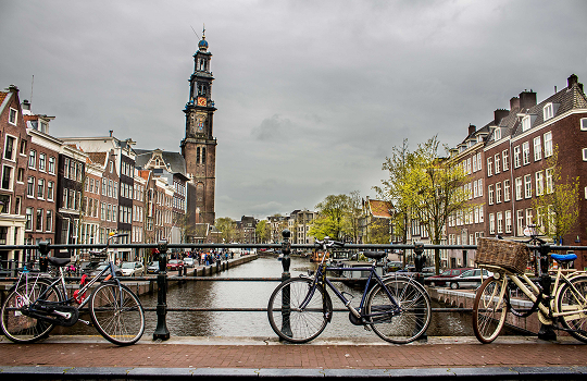 Beautiful Netherlands canal with historic buildings and bicycles